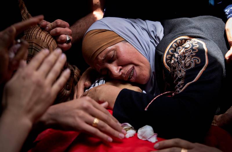 A Palestinian woman mourns her son Rasheed Abu Arra, who was killed during confrontations with Israeli forces, at his funeral in the village of Aqaba, near the West Bank town of Tubas. AP Photo