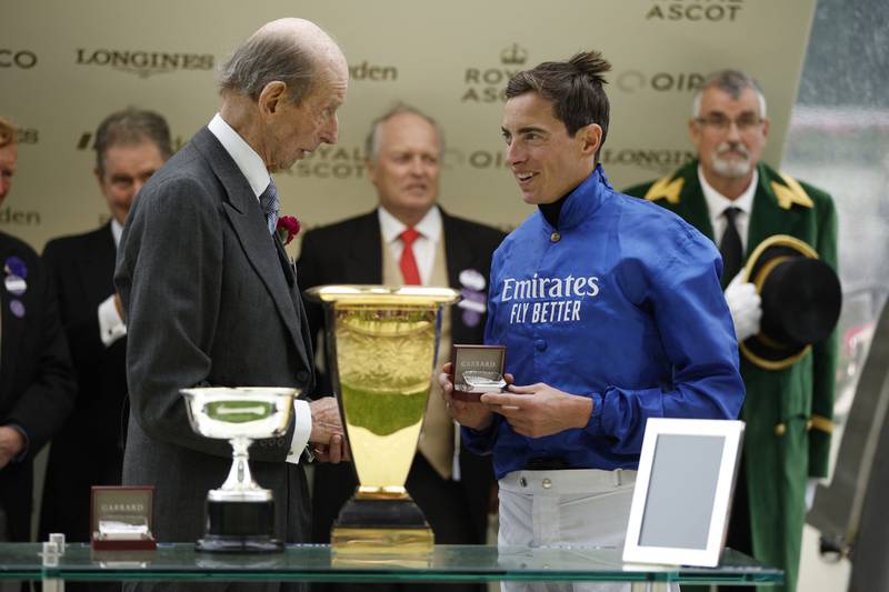 Britain's Prince Edward, the Duke of Kent, shakes hands with James Doyle during the trophy presentation. Reuters