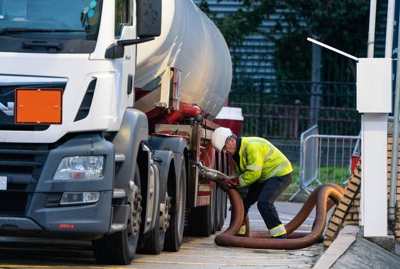 A tanker driver makes a fuel delivery at a petrol station in south London as the country experiences chronic shortages of HGV drivers. PA