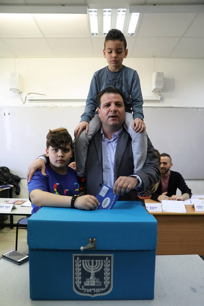 Ayman Odeh, leader of Hadash-Ta'al party, casts his ballot together with his sons as Israelis began voting in a parliamentary election, at a polling station in Haifa. Reuters
