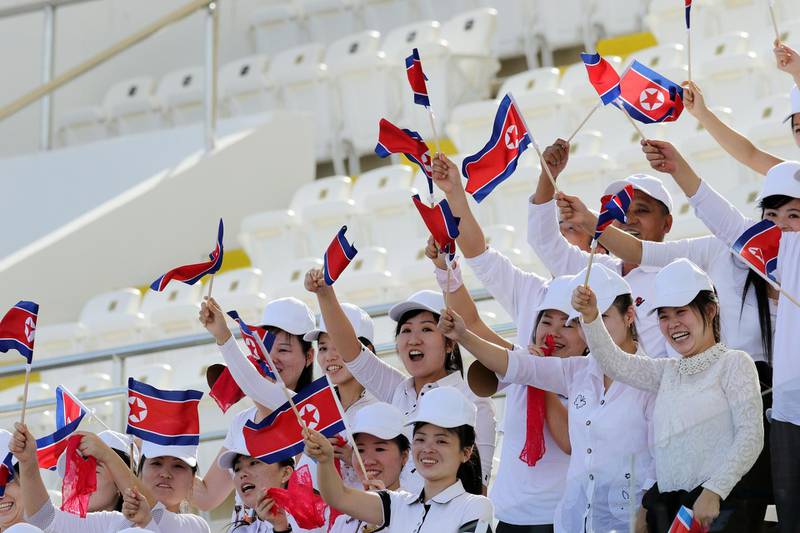North Korea fans cheer on their team against Qatar. EPA