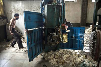 A worker gathers up imported sheep’s wool after it was processed and bleached at a factory near Zhangzhou. China is the major market for Australian wool, with more than 75 per cent of Ausralia's wool clip output exported to China for processing. Kevin Frayer / Getty Images