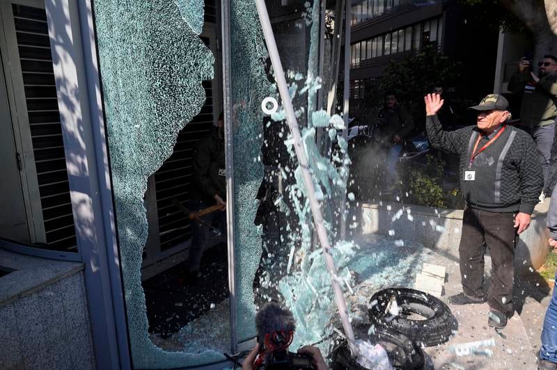 A bank customer smashes the glass of the entrance of BBAC bank during a protest organised by Depositors' Outcry, in Badaro neighborhood Beirut, Lebanon. EPA