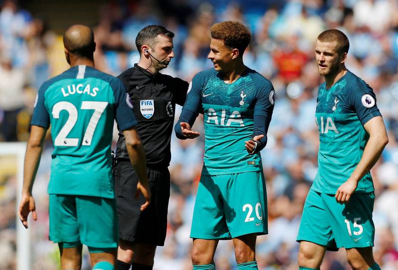 Alli speaks with referee Michael Oliver as Eric Dier and Lucas Moura look on. Reuters
