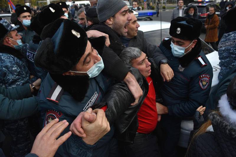 Police arrest a protester during a demonstration against Armenian Prime Minister Nikol Pashinyan in Yerevan. Armenians are upset by the government's agreement to cede three districts of Nagorno-Karabakh to Azerbaijan in addition four others seized by Azerbaijani forces during the fighting that began on September 27, 2020. AFP