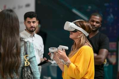 A visitor tests a virtual reality headset at the Dubai Metaverse Assembly at Museum of Future.