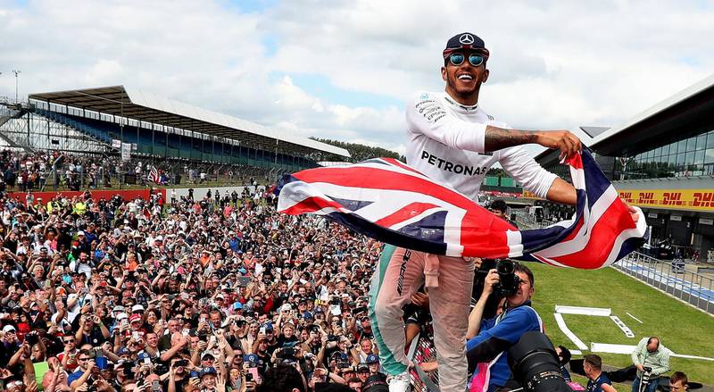 File photo dated 10-07-2016 of Lewis Hamilton celebrates his victory with the crowd after winning the 2016 British Grand Prix at Silverstone Circuit, Towcester. PA Photo. Issue date: Wednesday April 1, 2020. Silverstone has said it has until the end of April to decide whether or not the British Grand Prix can go ahead in July. See PA story SPORT Coronavirus Photo credit should read David Davies/PA Wire.