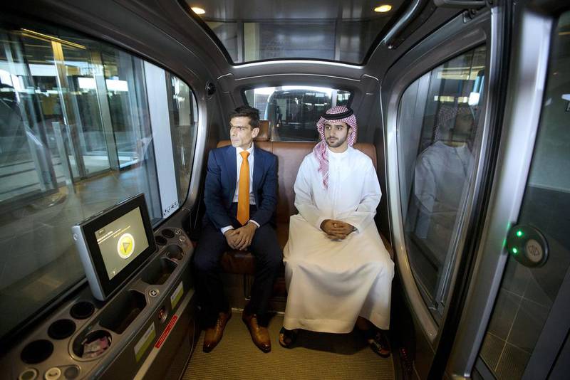 Professor Karim Karam, left, professor of engineering systems management, and Hamad Al Raqbani, research engineer, in a driverless vehicle at the Masdar Institute in Abu Dhabi. Christopher Pike / The National