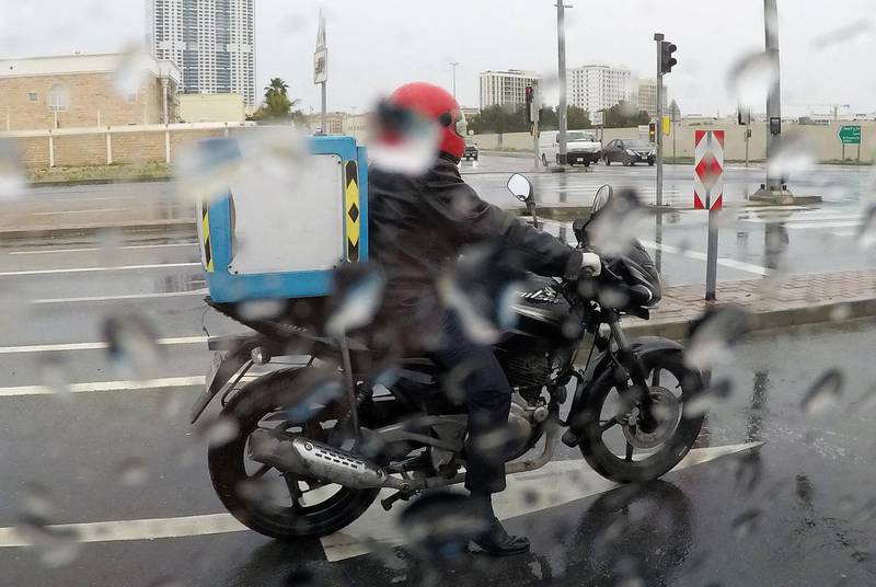DUBAI, UNITED ARAB EMIRATES , April 15 – 2020 :- One of the delivery driver during the rain in Al Barsha in Dubai.  (Pawan Singh/The National) For News/Standalone/Online/Instagram.
