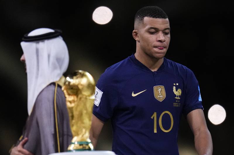 France's Kylian Mbappe walks past the trophy at the end of the match. AP