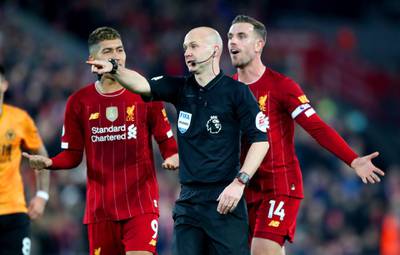Referee Anthony Taylor rules for Liverpool's Sadio Mane's goal to be checked by VAR for possible hand ball before it's given to put Liverpool 1-0 up during the Premier League match at Anfield Stadium, Liverpool. PA Photo. Picture date: Sunday December 29, 2019. See PA story SOCCER Liverpool. Photo credit should read: Nick Potts/PA Wire. RESTRICTIONS: EDITORIAL USE ONLY No use with unauthorised audio, video, data, fixture lists, club/league logos or "live" services. Online in-match use limited to 120 images, no video emulation. No use in betting, games or single club/league/player publications.