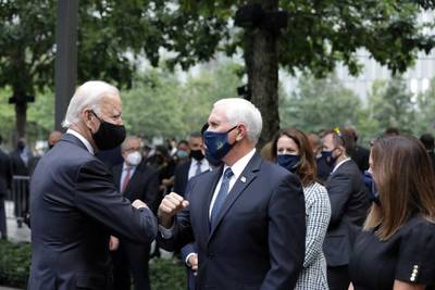 Democratic presidential candidate and former U.S. Vice President Joe Biden and Vice President Mike Pence greet each other during the 19th anniversary of the 9/11 attacks at the National September 11 Memorial & Museum in New York City, New York, U.S., September 11, 2020. Amr Alfiky/Pool via REUTERS     TPX IMAGES OF THE DAY