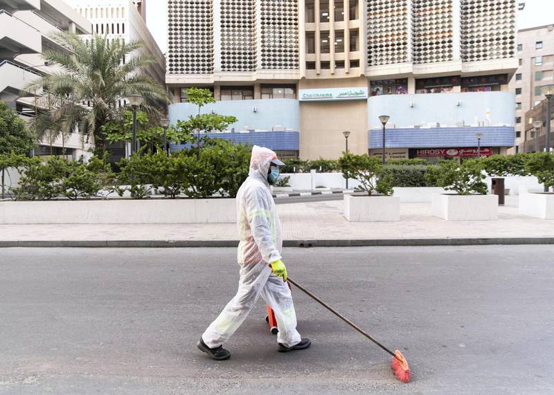 DUBAI, UNITED ARAB EMIRATES. 9 APRIL 2020. A man cleans the streets by Baniyas Square.(Photo: Reem Mohammed/The National)Reporter:Section: