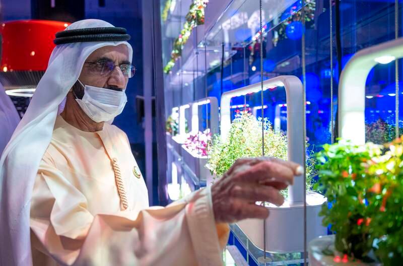 Sheikh Mohammed pauses to examine a horticulture exhibit during his visit. Sustainable food production is a focus of the Expo. WAM