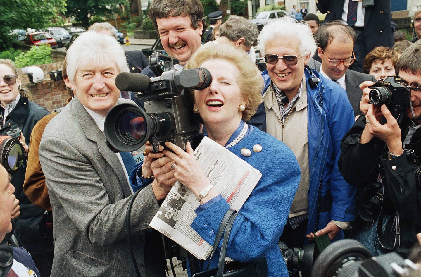 British Prime Minister Margaret Thatcher tries her hand with a television camera in London in 1987. AP Photo