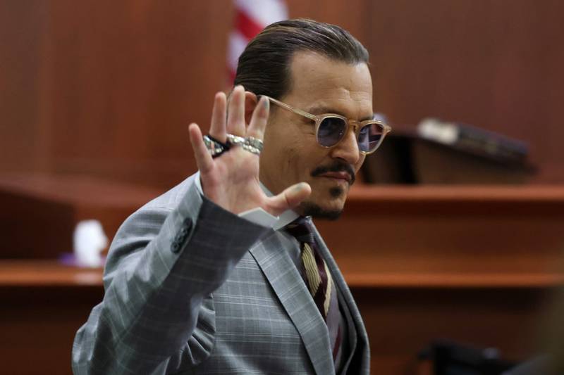 Depp waves to his courtroom fans. AFP