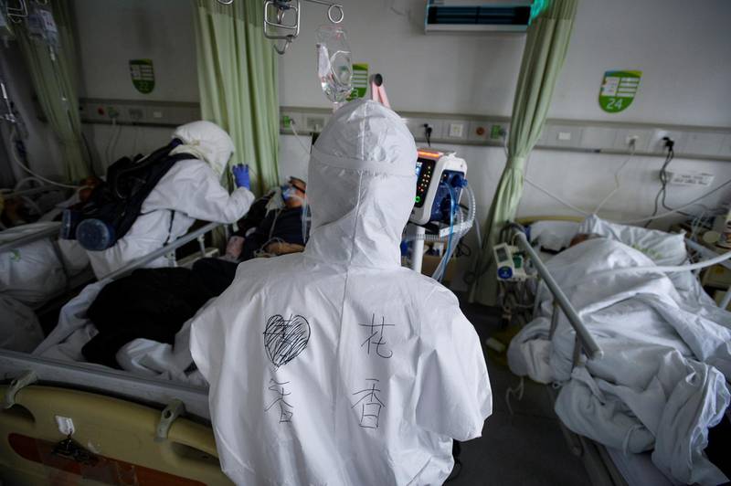 Medical workers in protective suits attend to novel coronavirus patients inside an isolated ward at a hospital in Wuhan, Hubei province, China. Reuters