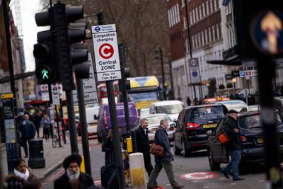 Signs indicating London congestion charges that drivers pay for entering the capital's central areas, which British financial services group Capita operates, are pictured on the streets of central London on February 1, 2018. 
The share price of British financial services group Capita plunged more than 40 percent on January 31, 2018, after the indebted outsourcing firm warned over future profits. / AFP PHOTO / Tolga Akmen