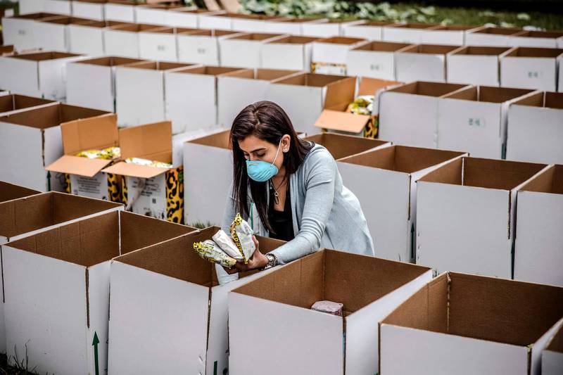 A volunteer prepares boxes with food and other basic goods at the Montessori School grounds in Nairobi, Kenya. The boxes will be delivered in the slums to people affected by the measures adopted by the Kenyan Government to stop the spread of Covid-19. Luis Tato / AFP