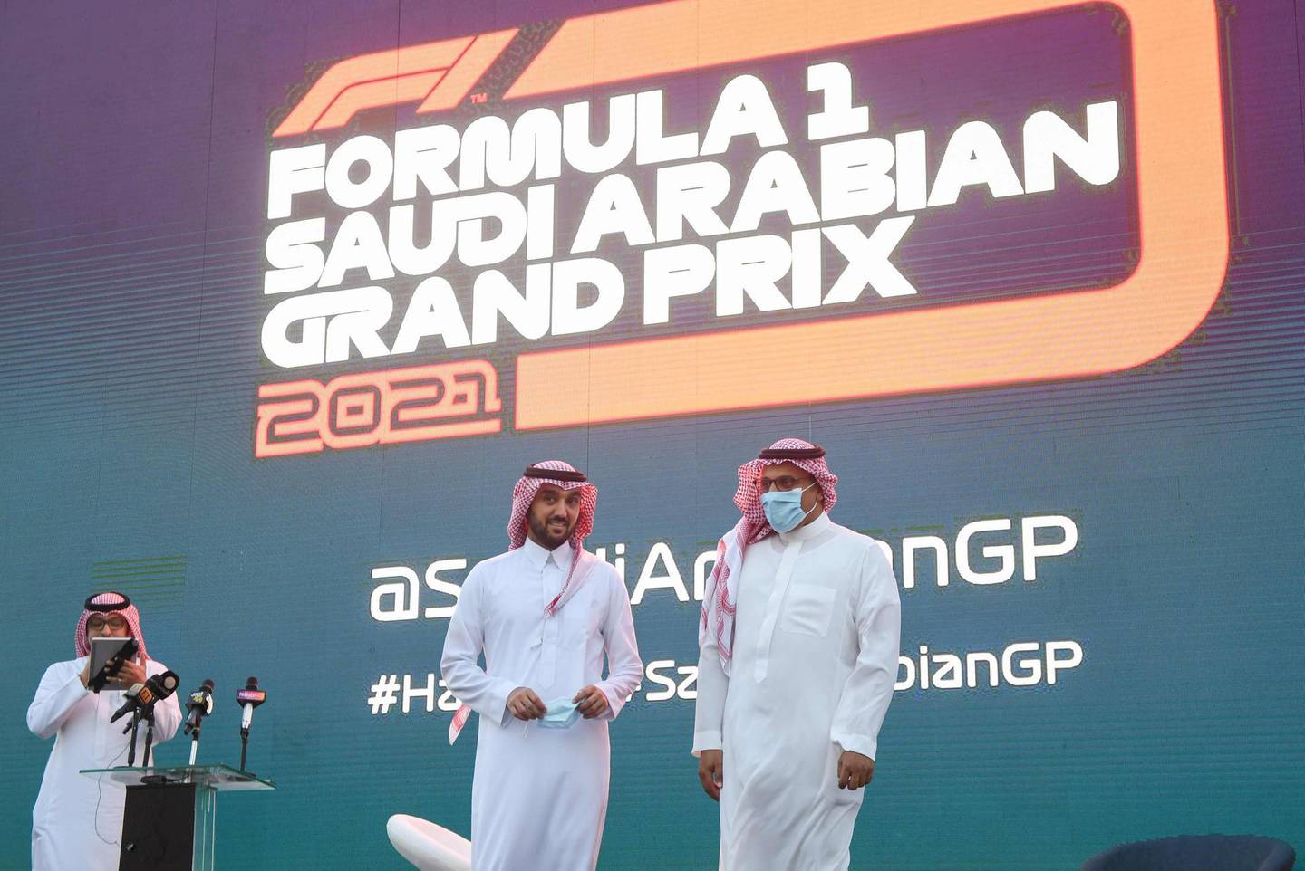Saudi Sports Minister Prince Abdulaziz bin Turki (C) and Khalid al-Faisal, Chairman of the Saudi Automobile and Motorcycle Federation, are pictured on stage during a press conference to announce Saudi Arabian Grand Prix as part of the 2021 F1 calendar, in the Red Sea coastal city of Jeddah on November 5, 2020. Saudi Arabia said it will host a Formula One Grand Prix for the first time next year, with a night race in the Red Sea city of Jeddah. Saudi Arabia had been pencilled in for the 2021 season as part of a record 23-race Formula One programme, as the sport seeks to bounce back from a shortened 2020 season that has been disrupted by the coronavirus pandemic.  / AFP / Amer HILABI
