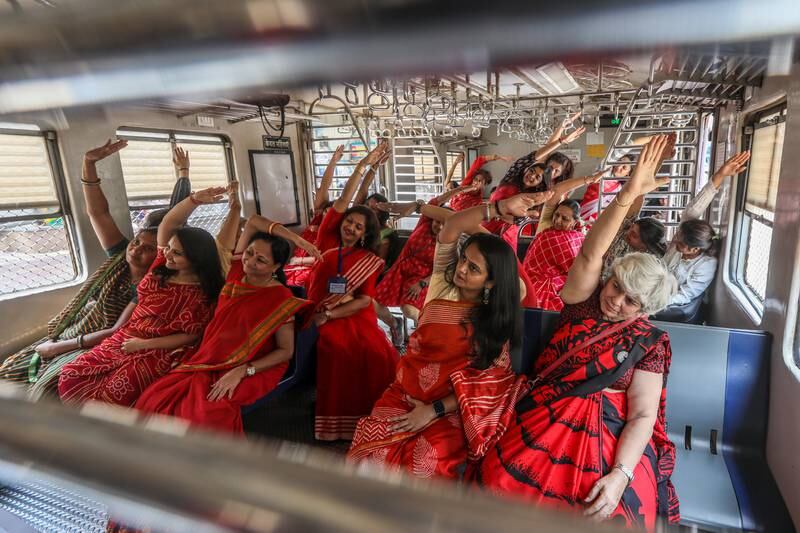 Indian women perform yoga inside a local train organised by Heal-Station and the Western Railway, in Mumbai, India. EPA
