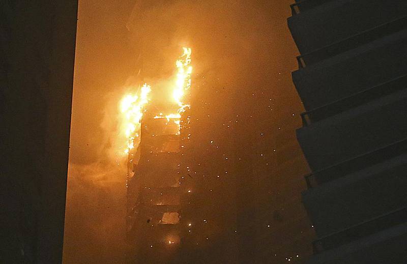 Flames billow from the fire at Marina Torch in Dubai Marina, which started about 2am on Saturday. Sarah Dea / The National