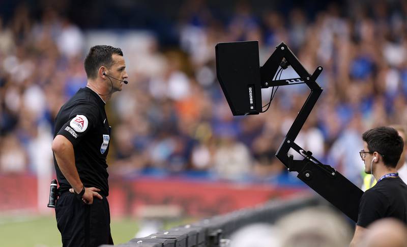 Referee Andrew Madley consults the pitch side monitor for a VAR decision during the Premier League match at Stamford Bridge, London. PA