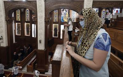 People wear face masks and observe social distance during a mass at Virgin Mary Church in Dokki district in Cairo, Egypt.  EPA