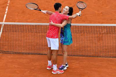 Novak Djokovic hugs Jelena Jankovic during a tennis doubles against Serbia's Nenad Zimonjic and Olga Danilovic at a charity exhibition hosted by Novak Djokovic, in Belgrade. AFP