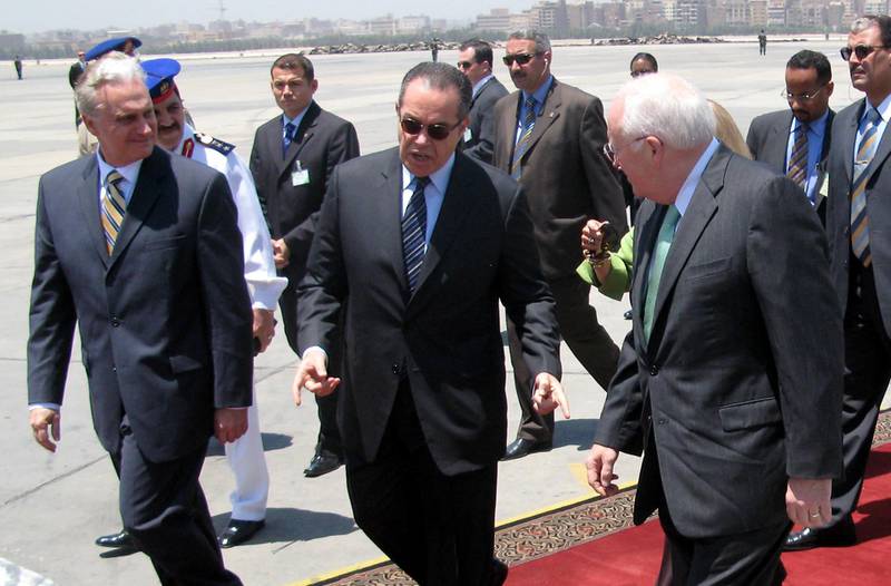 US Vice President Dick Cheney (R) is greeted by Egyptian Transportation Minister Mohammed Mansur (C) and other Egyptian officials upon his arrival to Cairo with his daughter Liz Cheney (not seen), 13 May 2007. Cheney continued his Middle East tour with a lightning stop in Egypt today for talks with President Hosni Mubarak on helping Iraq and curbing Iran's rising influence. Cheney went into talks with Mubarak, a close US ally, to seek help in drawing Iraq's minority Sunni Muslims into the country's fragile political process. The two men are also expected to discuss Shiite Iran's increasing power in the region, just as Iran announced it was ready to hold talks with the United Sates in a bid to improve security in Iraq. AFP PHOTO/OLIVIER KNOX (Photo by OLIVIER KNOX / AFP)