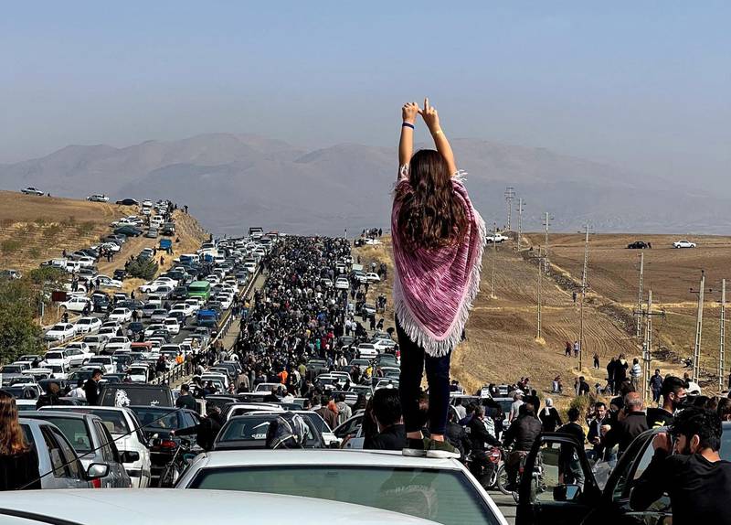An unveiled woman stands on a car as thousands make their way to Aichi cemetery in Saqez, Mahsa Amini's home town in the western Iranian province of Kurdistan, to mark 40 days since her death. AFP
