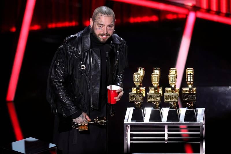 Post Malone accepts awards onstage at the Billboard Music Awards. Reuters