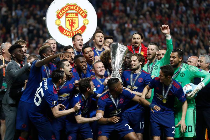 Manchester United's players and Wayne Rooney  with the trophy after the Europa League final against Ajax at the Friends Arena in Solna outside Stockholm on May 24, 2017. AFP