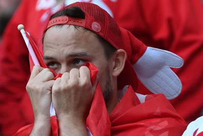 Fans react after Christian Eriksen's collapse. AFP