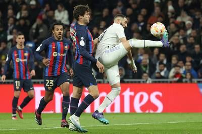 Real Madrid's Karim Benzema in action against Marcos Alonso of Barcelona. EPA
