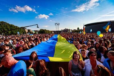 A giant Ukrainian flag is held up during the benefit concert 'Embrace Ukraine' on the Museumplein in Amsterdam.  The free event will raise money for victims of the war in Ukraine and the purchase of mobile X-ray equipment that the country needs.   EPA 