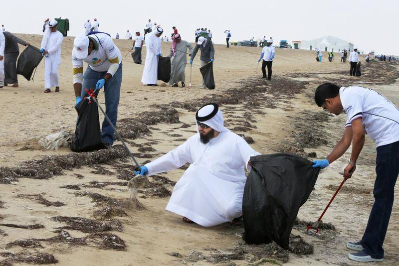 Organisers and volunteers fill bags with used water bottles, old cans, bits of wood and a huge haul of plastic rubbish as they work their way along Hameem Beach in Al Dhafra. Delores Johnson / The National