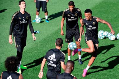 Eder Militao, right, Raphael Varane, centre, and Thibaut Courtois take part in training session. AFP