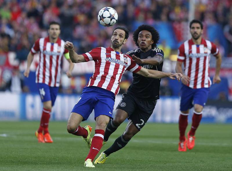 Atletico Madrid player Juanfran, left, clears the ball from Chelsea player Willian during their Champions League contest on Tuesday. Andres Kudacki / AP / April 22, 2014
