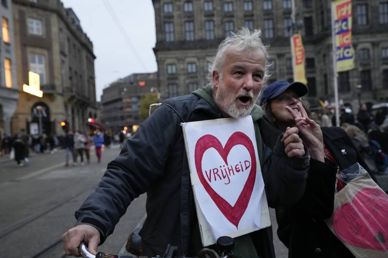 Anti-lockdown demonstrators in the Dutch capital of Amsterdam used innovative ways to express their anger, such as this man who carried a poster reading 'Freedom'. AP Photo