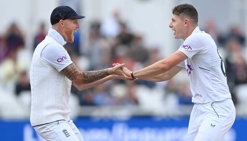 England bowler Matthew Potts, right, celebrates with captain Ben Stokes after taking the wicket of Henry Nicholls for three. Getty