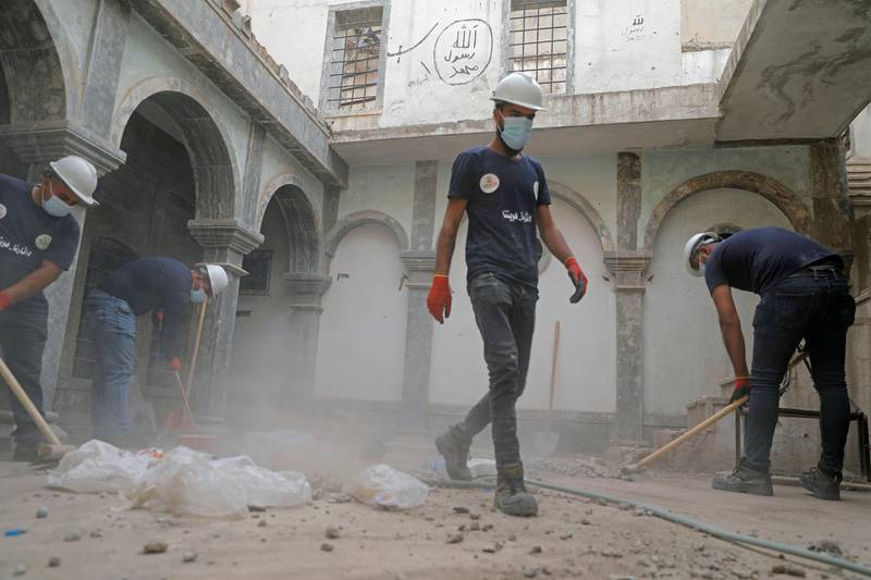 A group of young volunteers works to clean the Church of Saint Thomas, as they help Iraqi Christians in the Old City of Mosul, Iraq October 28, 2020. Picture taken October 28, 2020. REUTERS/Abdullah Rashid