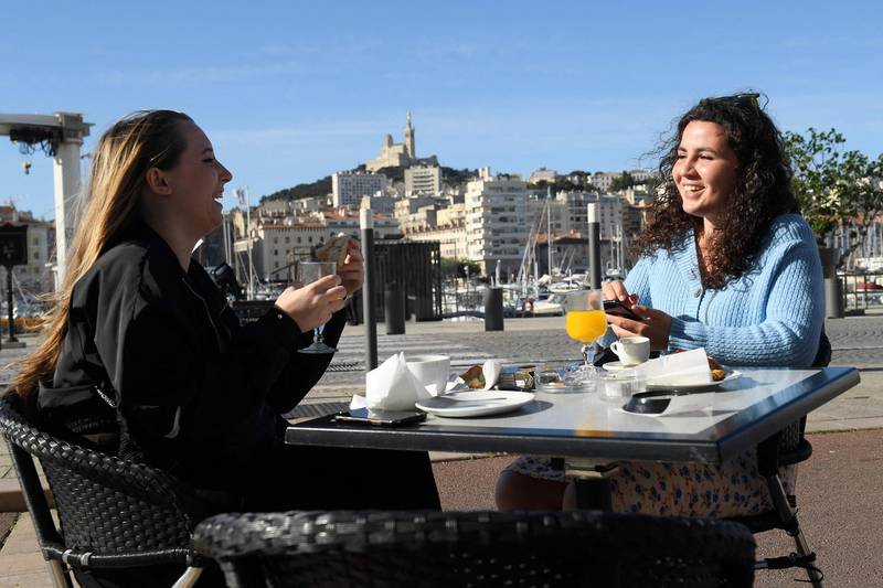 Customers have breakfast as they sit on a terrace at the Vieux-Port in Marseille, southern France. AFP