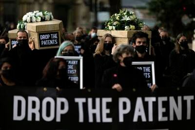 Campaigners carry fake coffins in London to highlight the number of Covid-19 deaths globally. AP