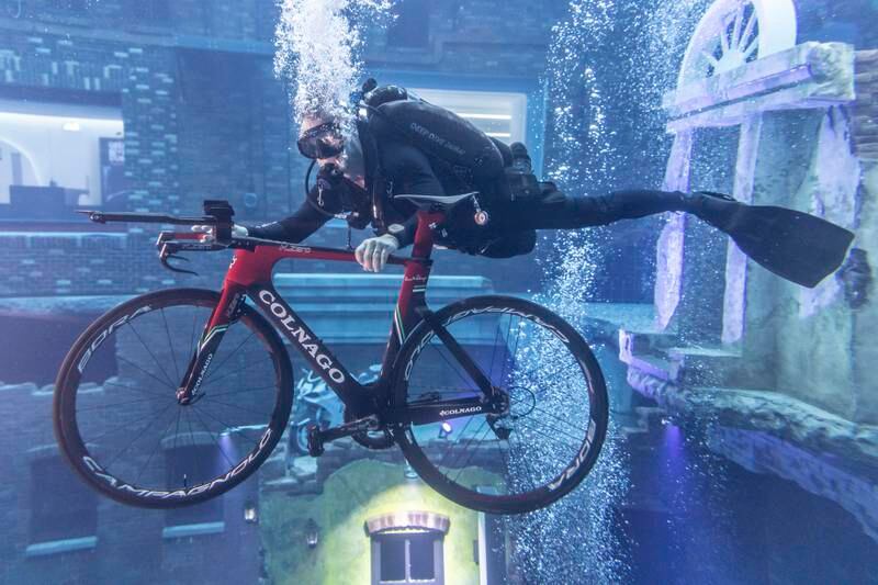 Diver Richard Lundgren with a bicycle in Deep Dive Dubai, the world's deepest pool. All photos: Antonie Robertson / The National

