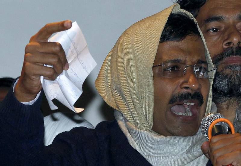 Arvind Kejriwal waves his resignation letter as he addresses supporters at the Aam Aadmi (Common Man) Party offices in New Delhi on February 14. AFP