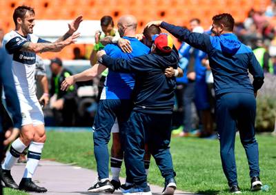 Diego Maradona and celebrates with his assistants. AFP