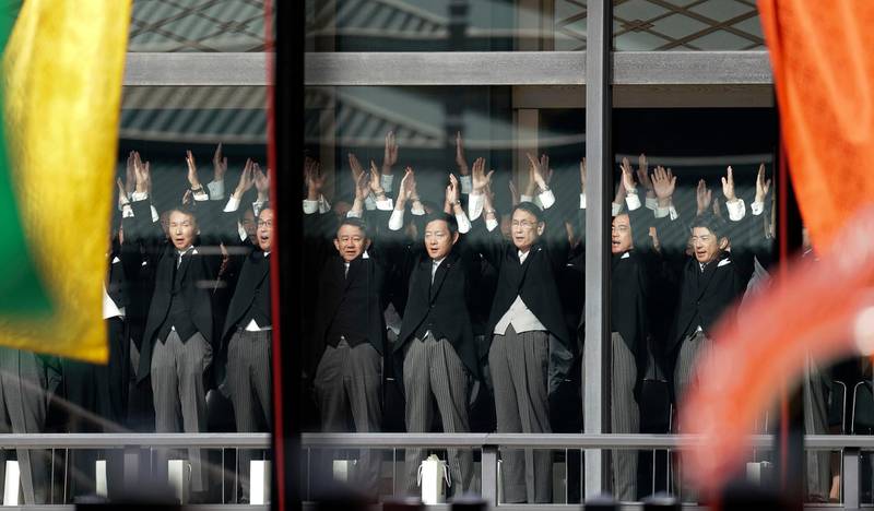 Attendants chant "Banzai" cheer during the enthronement ceremony after Japanese Emperor Naruhito proclaimed his enthronement at the Imperial Palace in Tokyo.  AP