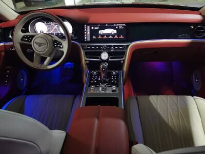 The cabin comes in two-toned Flare Red and cream leather offset by piano-black veneer