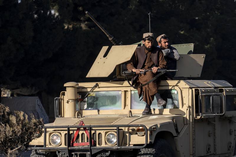 Taliban fighters on guard at the site of an explosion near a military airfield in Kabul. AP